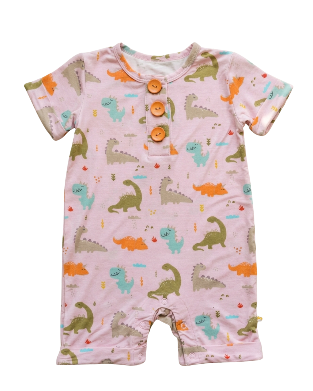 A baby short-sleeve romper in light pink with an all-over dinosaur print in orange, green, and blue. It features a three-button henley neckline with wooden buttons.